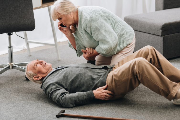 A wife helping her husband who has fallen while calling for help.