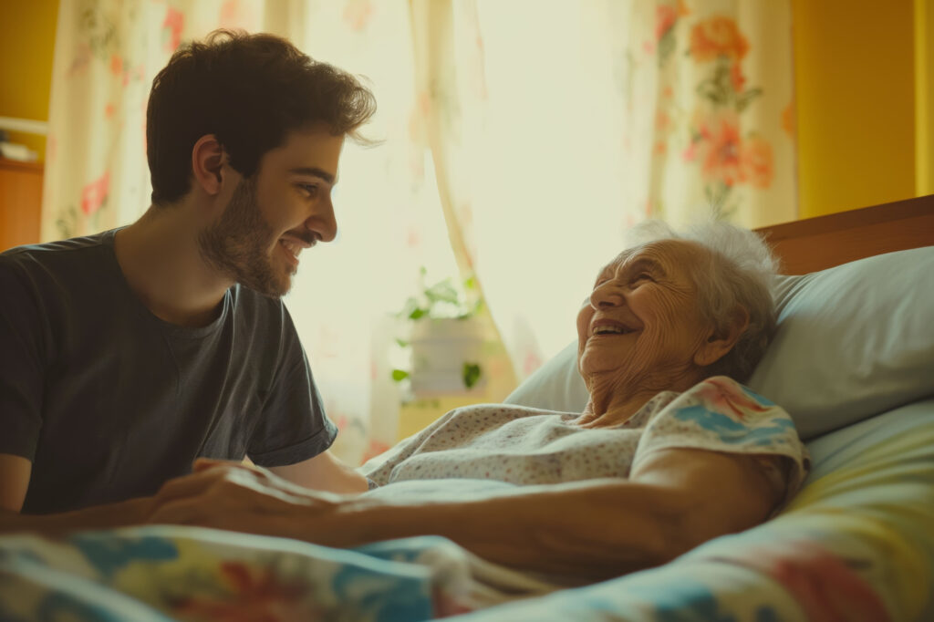 A grandson visiting with his grandmother.