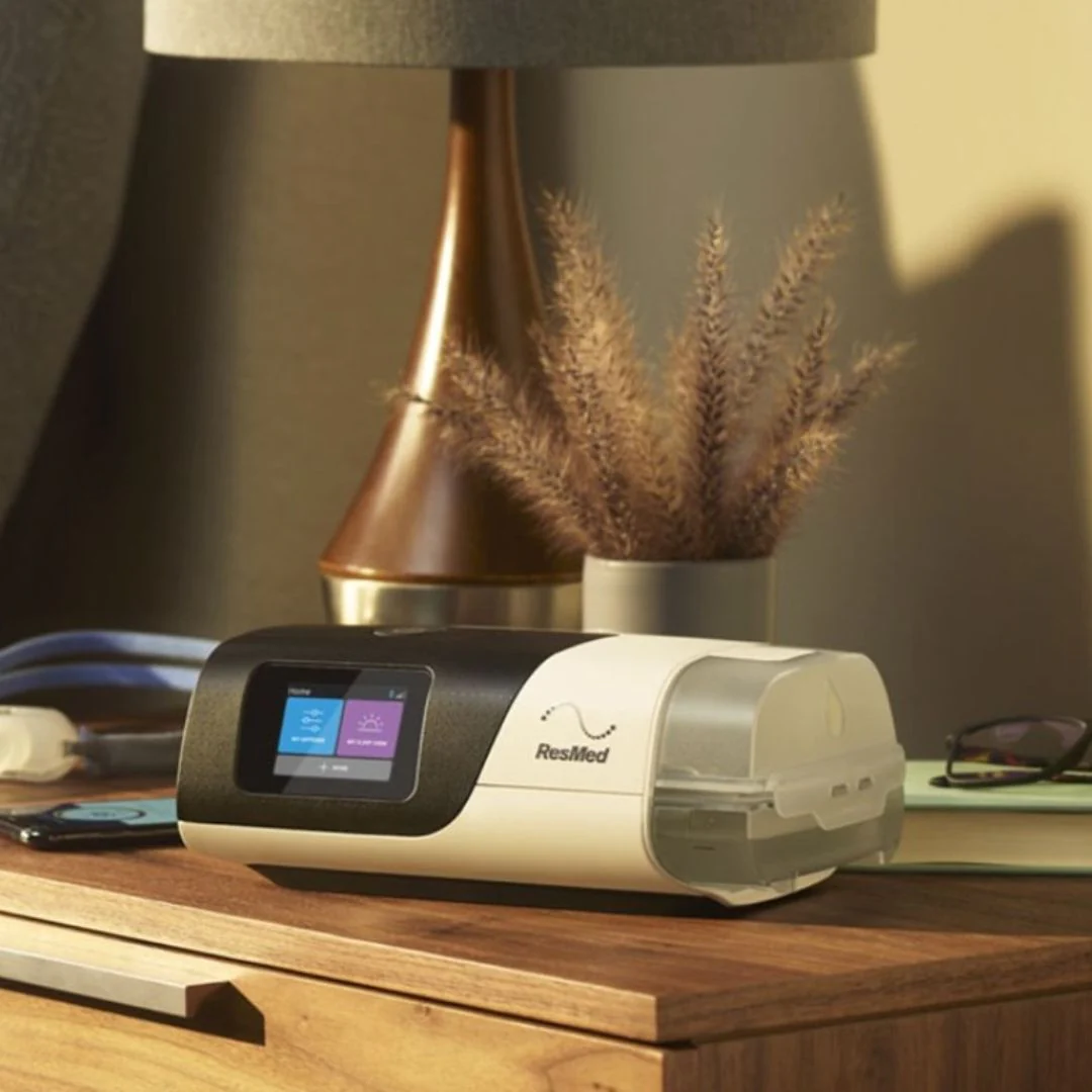 A ResMed CPAP machine on a night stand.