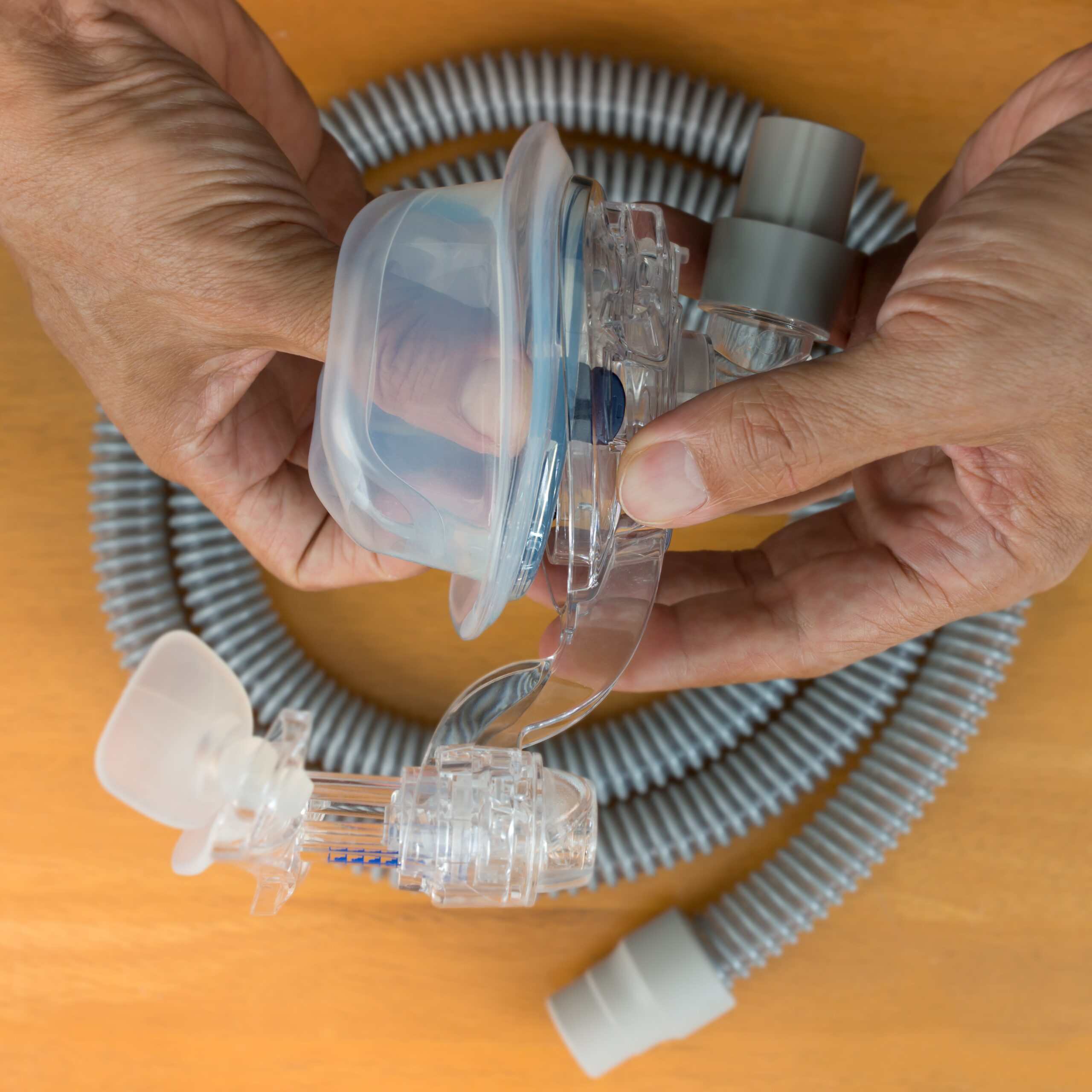 A person cleaning their CPAP mask.